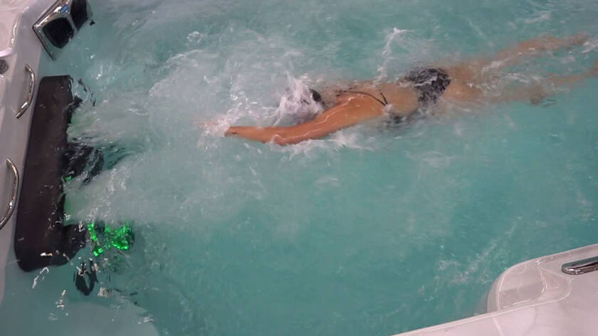 Woman exercising with swim spa resistance training